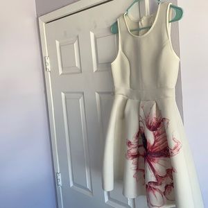 WHITE DRESS WITH AN ORCHID IN THE MIDDLE